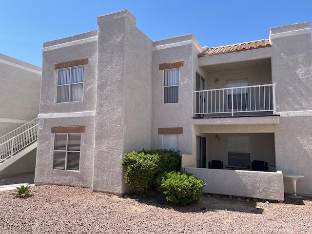6800 E Lake Mead Blvd Unit 2024, Las Vegas, NV 89156 - view of side of home featuring a balcony and stucco siding