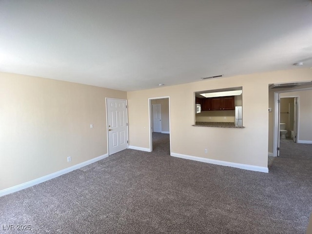 6800 E Lake Mead Blvd Unit 2024, Las Vegas, NV 89156 - unfurnished living room featuring dark colored carpet and baseboards
