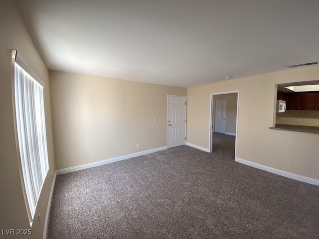 6800 E Lake Mead Blvd Unit 2024, Las Vegas, NV 89156 - unfurnished room featuring dark carpet and plenty of natural light