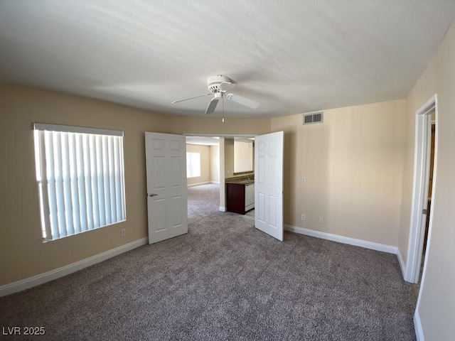 6800 E Lake Mead Blvd Unit 2024, Las Vegas, NV 89156 - unfurnished bedroom featuring carpet flooring, multiple windows, and ceiling fan