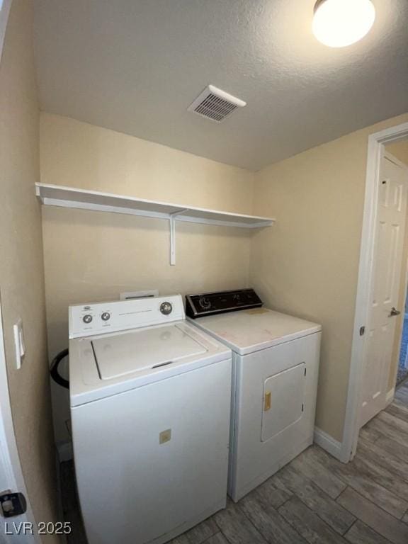 6800 E Lake Mead Blvd Unit 2024, Las Vegas, NV 89156 - laundry room featuring washer and dryer and light wood-style floors