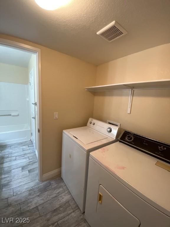 6800 E Lake Mead Blvd Unit 2024, Las Vegas, NV 89156 - laundry room with washing machine and clothes dryer and baseboards