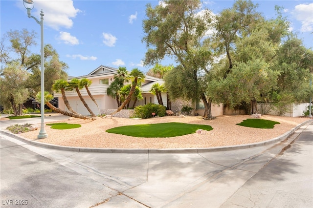 226 Dalmatian Ln, Las Vegas, NV 89107 - view of front of home with stucco siding and curved driveway