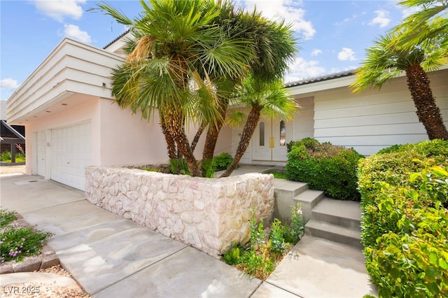 226 Dalmatian Ln, Las Vegas, NV 89107 - view of front of home featuring a garage, concrete driveway, and stucco siding