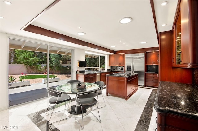 226 Dalmatian Ln, Las Vegas, NV 89107 - kitchen with stainless steel appliances, a center island, recessed lighting, dark brown cabinets, and tasteful backsplash