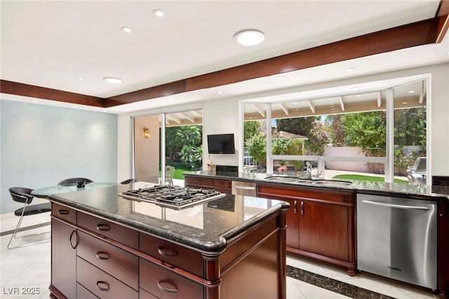 226 Dalmatian Ln, Las Vegas, NV 89107 - kitchen with stainless steel appliances, a center island, inlaid floor details, dark stone countertops, and recessed lighting