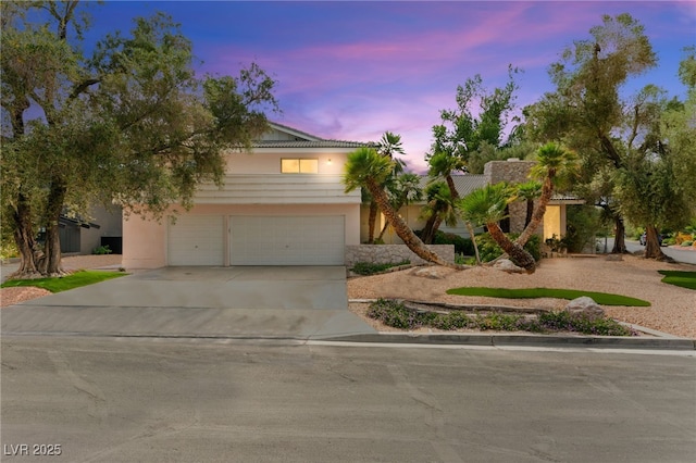 226 Dalmatian Ln, Las Vegas, NV 89107 - view of front of house with concrete driveway, stucco siding, and a garage