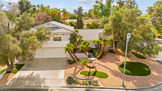 226 Dalmatian Ln, Las Vegas, NV 89107 - view of front facade featuring a tile roof, a garage, and concrete driveway