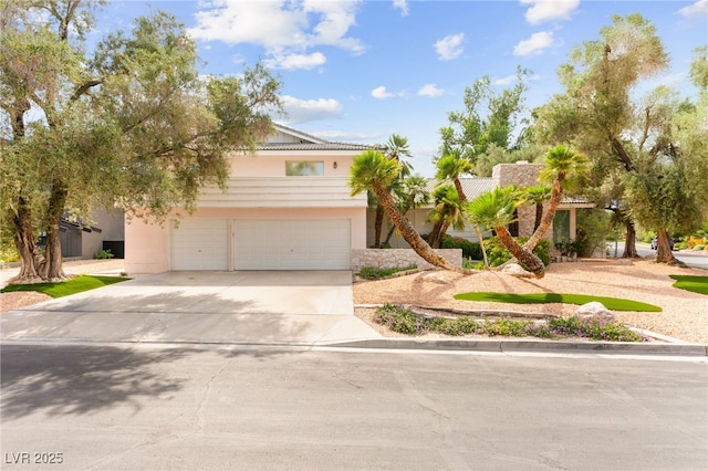 226 Dalmatian Ln, Las Vegas, NV 89107 - view of front of home featuring concrete driveway, an attached garage, and stucco siding