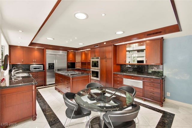 226 Dalmatian Ln, Las Vegas, NV 89107 - kitchen with appliances with stainless steel finishes, inlaid floor details, a warming drawer, decorative backsplash, and recessed lighting