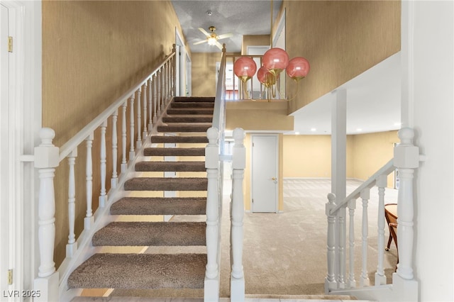 226 Dalmatian Ln, Las Vegas, NV 89107 - stairway featuring carpet floors, a ceiling fan, and a towering ceiling