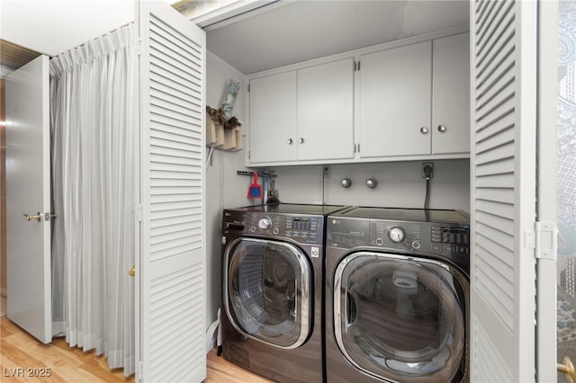 226 Dalmatian Ln, Las Vegas, NV 89107 - laundry area featuring independent washer and dryer, light wood finished floors, and cabinet space