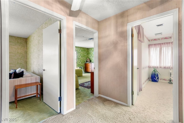 226 Dalmatian Ln, Las Vegas, NV 89107 - corridor with carpet, a textured ceiling, and wallpapered walls