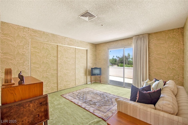 226 Dalmatian Ln, Las Vegas, NV 89107 - carpeted living room with wallpapered walls and a textured ceiling