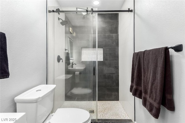 3825 Manhattan Bridge Pl, North Las Vegas, NV 89032 - full bathroom with a stall shower and a textured wall