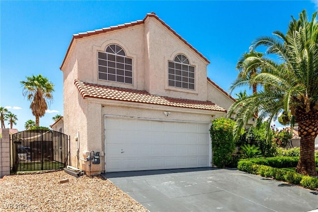3825 Manhattan Bridge Pl, North Las Vegas, NV 89032 - mediterranean / spanish house featuring stucco siding, a tiled roof, a gate, concrete driveway, and an attached garage