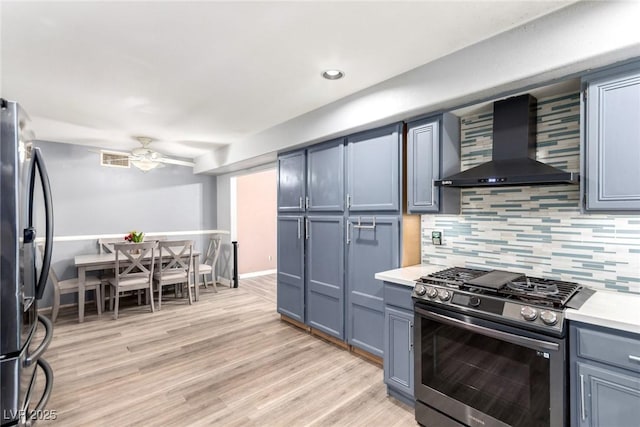 3825 Manhattan Bridge Pl, North Las Vegas, NV 89032 - kitchen featuring wall chimney range hood, stainless steel appliances, decorative backsplash, light countertops, and recessed lighting
