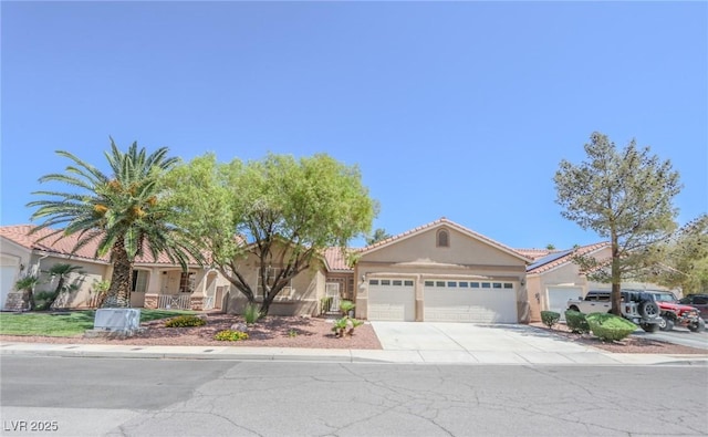 1174 Monogram Way, Las Vegas, NV 89123 - view of front of house featuring stucco siding, concrete driveway, a garage, and a tiled roof