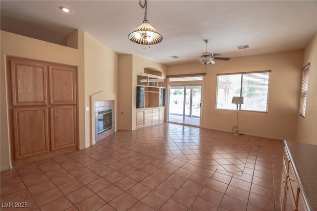 1174 Monogram Way, Las Vegas, NV 89123 - unfurnished living room featuring a tiled fireplace, ceiling fan, recessed lighting, and light tile patterned floors