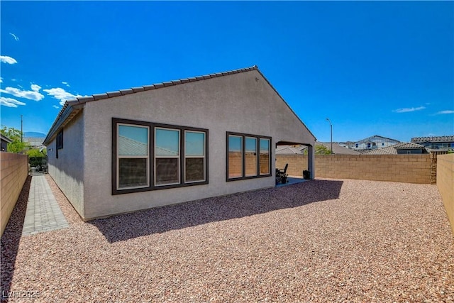 8286 Skye Gorge St, Las Vegas, NV 89166 - rear view of house featuring stucco siding, a fenced backyard, and a patio