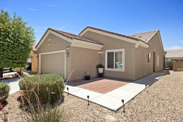 2117 Bay Thrush Way N, Las Vegas, NV 89084 - view of home's exterior with a garage, stucco siding, and a tiled roof