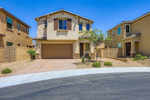 5606 Verde Valley Ct, North Las Vegas, NV 89081 - view of front of property featuring stucco siding, a garage, a tile roof, driveway, and stone siding