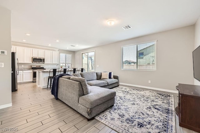 5606 Verde Valley Ct, North Las Vegas, NV 89081 - living room featuring light wood finished floors and recessed lighting