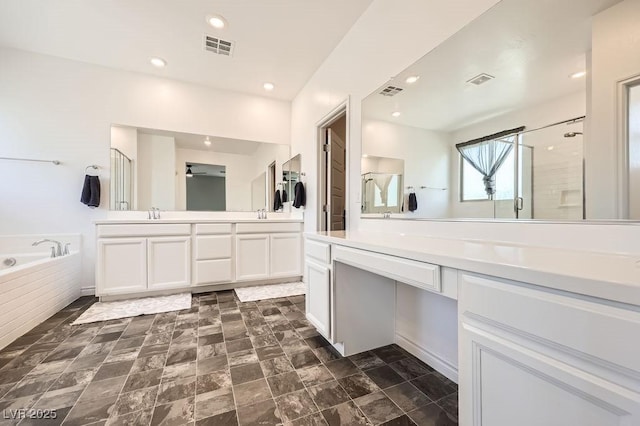 5606 Verde Valley Ct, North Las Vegas, NV 89081 - bathroom with double vanity, a stall shower, a bath, and recessed lighting