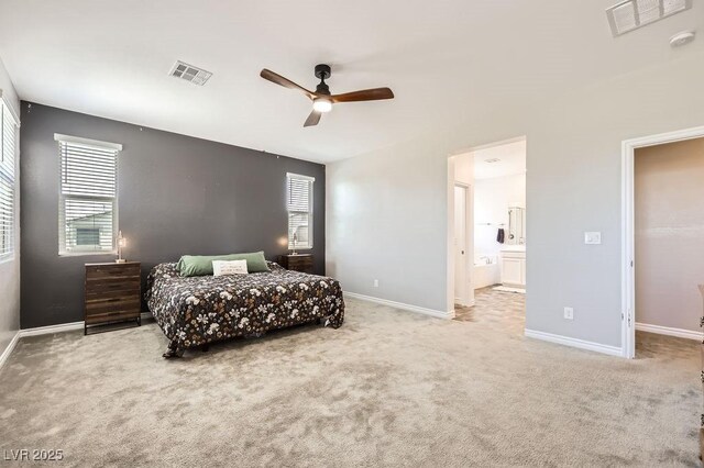 5606 Verde Valley Ct, North Las Vegas, NV 89081 - carpeted bedroom with multiple windows, ensuite bathroom, and ceiling fan