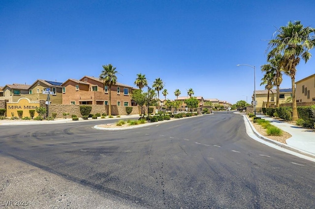 5606 Verde Valley Ct, North Las Vegas, NV 89081 - view of asphalt street featuring a residential view, sidewalks, street lighting, and curbs