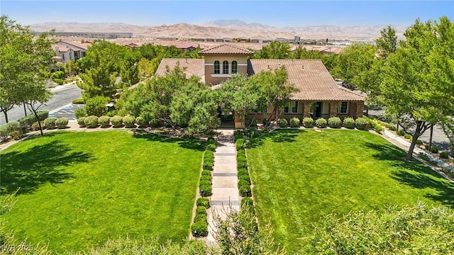 1922 Via Delle Arti, Henderson, NV 89044 - mediterranean / spanish-style house featuring a tile roof, a front yard, a mountain view, and stucco siding