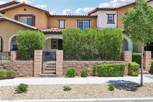 1922 Via Delle Arti, Henderson, NV 89044 - mediterranean / spanish home featuring stucco siding, a gate, a tiled roof, and a fenced front yard