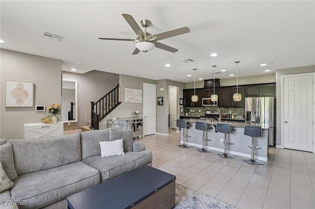 1922 Via Delle Arti, Henderson, NV 89044 - living room with stairs, a ceiling fan, and recessed lighting