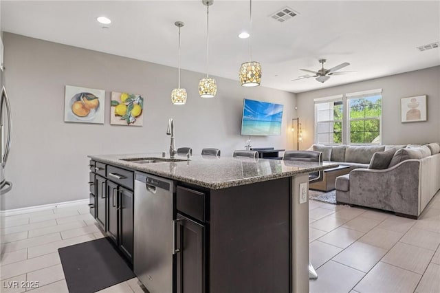1922 Via Delle Arti, Henderson, NV 89044 - kitchen featuring stainless steel dishwasher, open floor plan, stone counters, a ceiling fan, and light tile patterned floors