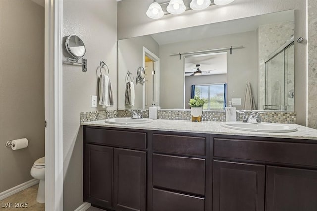 1922 Via Delle Arti, Henderson, NV 89044 - full bath featuring double vanity, a shower stall, a ceiling fan, and tile patterned floors