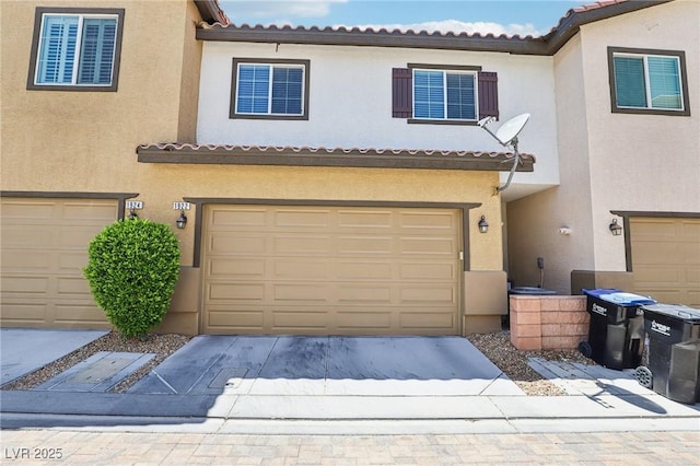 1922 Via Delle Arti, Henderson, NV 89044 - view of front of house featuring driveway, an attached garage, stucco siding, and a tile roof