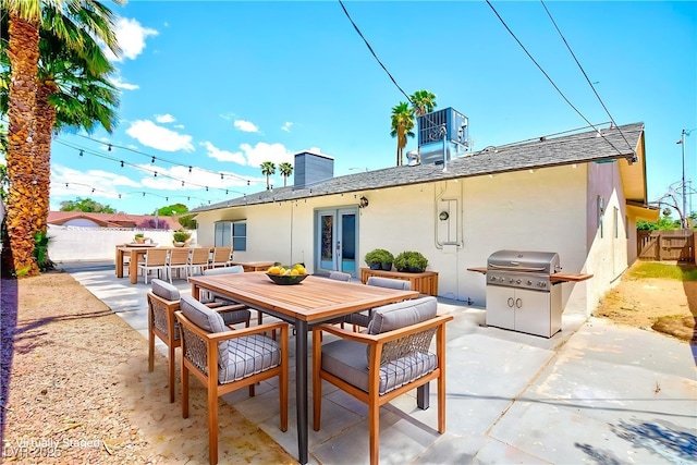 1700 Ivanhoe Way, Las Vegas, NV 89102 - fenced backyard featuring area for grilling, a patio, outdoor dining area, and french doors