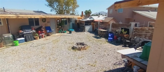 5068 Killarney St, Las Vegas, NV 89122 - view of yard with an outdoor fire pit