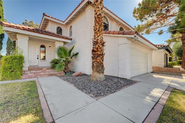 8809 Beach Front Dr, Las Vegas, NV 89117 - mediterranean / spanish home with a tile roof, stucco siding, and concrete driveway