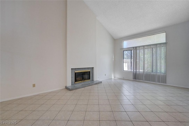 8809 Beach Front Dr, Las Vegas, NV 89117 - unfurnished living room featuring high vaulted ceiling, a fireplace, light tile patterned flooring, and a textured ceiling