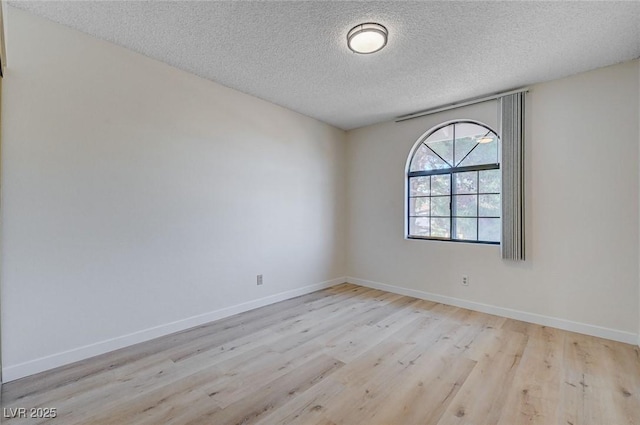 8809 Beach Front Dr, Las Vegas, NV 89117 - unfurnished room with a textured ceiling and wood finished floors