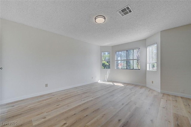 8809 Beach Front Dr, Las Vegas, NV 89117 - unfurnished room featuring light wood finished floors and a textured ceiling