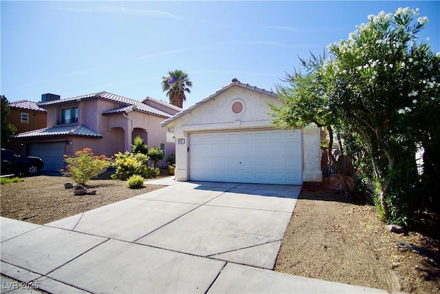 6131 Pumpkin Patch Ave, Las Vegas, NV 89142 - mediterranean / spanish house featuring driveway, stucco siding, a tile roof, and an attached garage