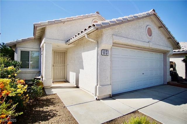 6131 Pumpkin Patch Ave, Las Vegas, NV 89142 - view of front of home with stucco siding, a garage, and a tile roof