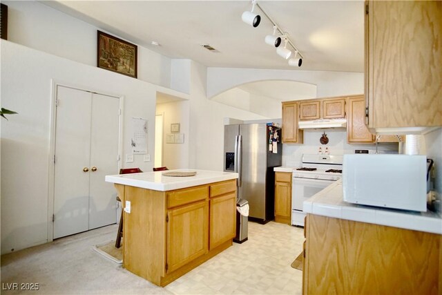 6131 Pumpkin Patch Ave, Las Vegas, NV 89142 - kitchen with white appliances, light countertops, under cabinet range hood, rail lighting, and a center island