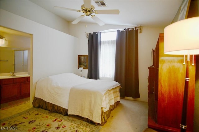 6131 Pumpkin Patch Ave, Las Vegas, NV 89142 - bedroom featuring connected bathroom, vaulted ceiling, ceiling fan, and light colored carpet