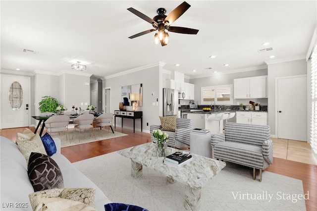 11649 Royal Derwent Dr, Las Vegas, NV 89138 - living room with light wood finished floors, a ceiling fan, ornamental molding, and recessed lighting