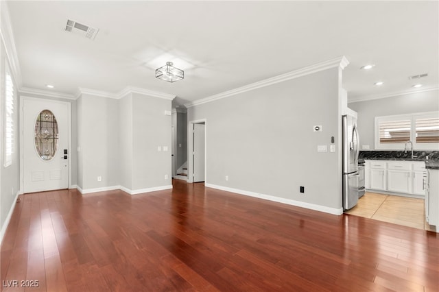 11649 Royal Derwent Dr, Las Vegas, NV 89138 - unfurnished living room featuring light wood-type flooring, ornamental molding, stairs, and recessed lighting