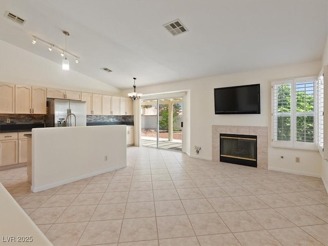 4323 Pageantry Falls Dr, North Las Vegas, NV 89031 - kitchen featuring stainless steel fridge, lofted ceiling, a chandelier, decorative backsplash, and healthy amount of natural light