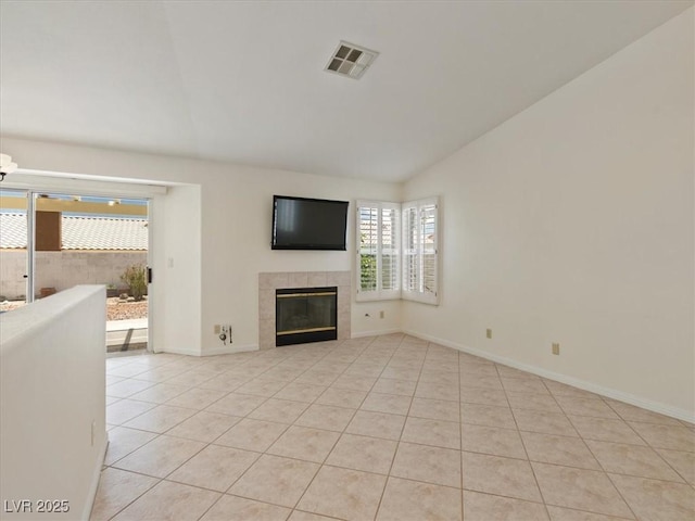 4323 Pageantry Falls Dr, North Las Vegas, NV 89031 - unfurnished living room featuring lofted ceiling, light tile patterned floors, healthy amount of natural light, and a tiled fireplace